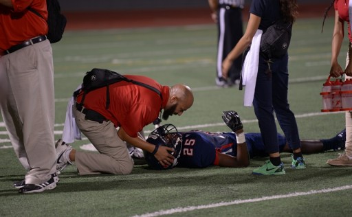 Renee Fernandes/NATA Aaron Ellis, MEd, ATC, LAT, the athletic trainer at Kimball High School in Dallas, TX helps kids on the field and on the sidelines during the football team's opening game.